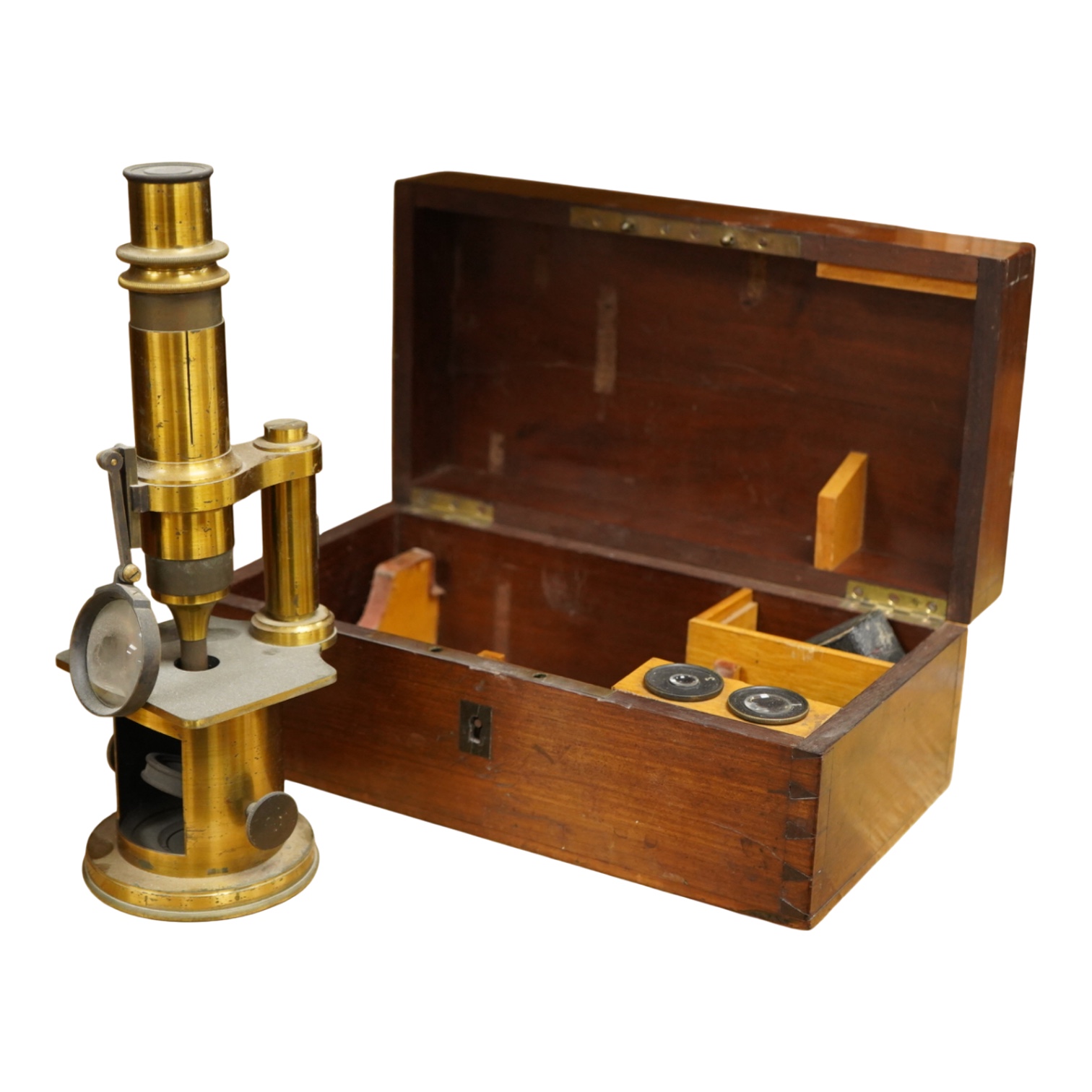 A mid 19th century French brass compound monocular microscope, by Nachet, Optician, Rue Serpente 16, Paris, with two eyepieces, three objectives and several slides, mahogany cased, instrument height 23cm